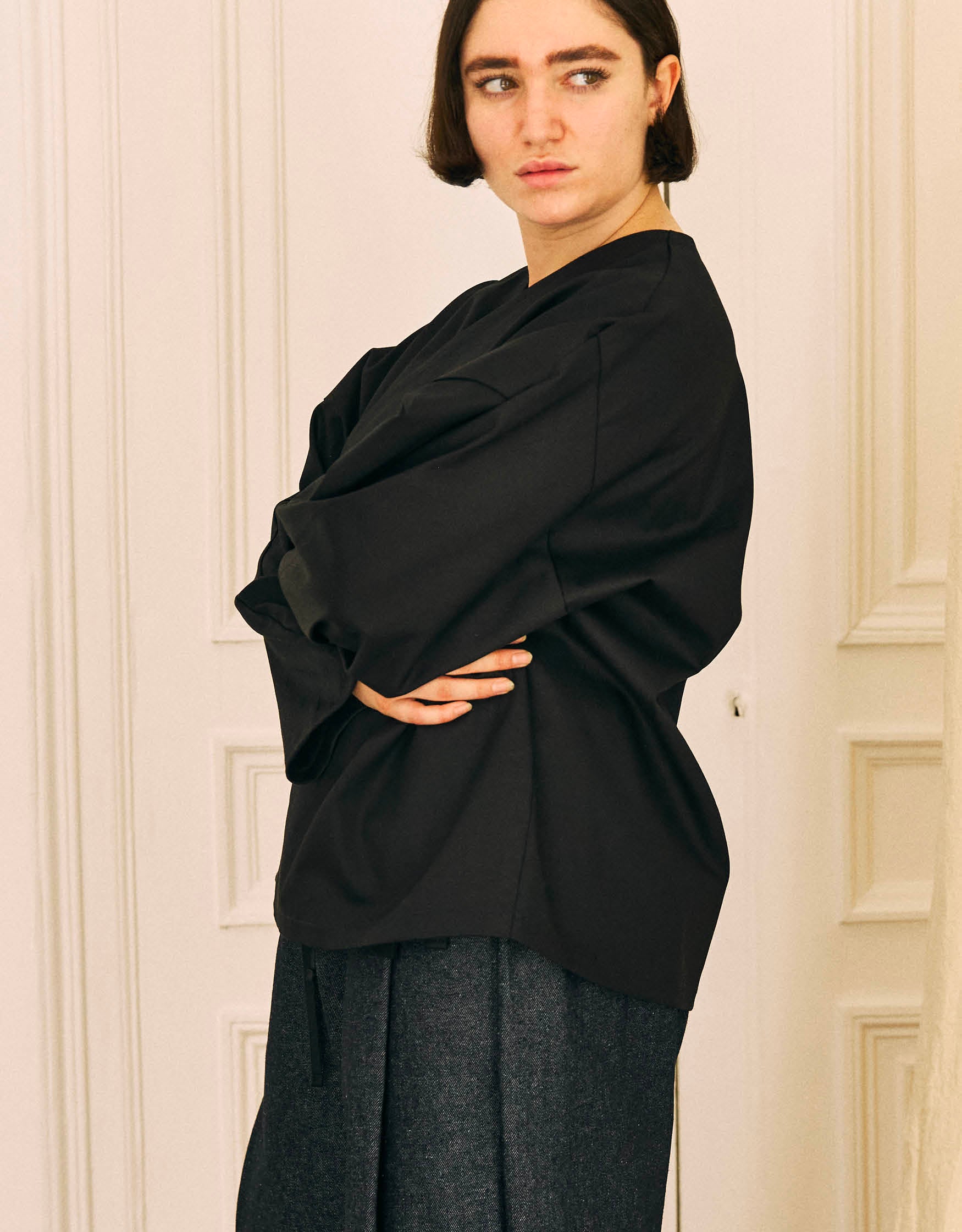 Unisex kimono, straight cut, oversized, low armholes, quilted strap at the bottom of the sleeves to modify volume, asymmetrical lines, cross-over front, closes with cotton taffeta ties of different widths. Designed to be worn both closed and open as an overshirt.&nbsp;

Made in France, in a Black stretch cotton gabardine, 98% Cotton, 2% Elastane, 251g/m², from a fashion house's dead stock.