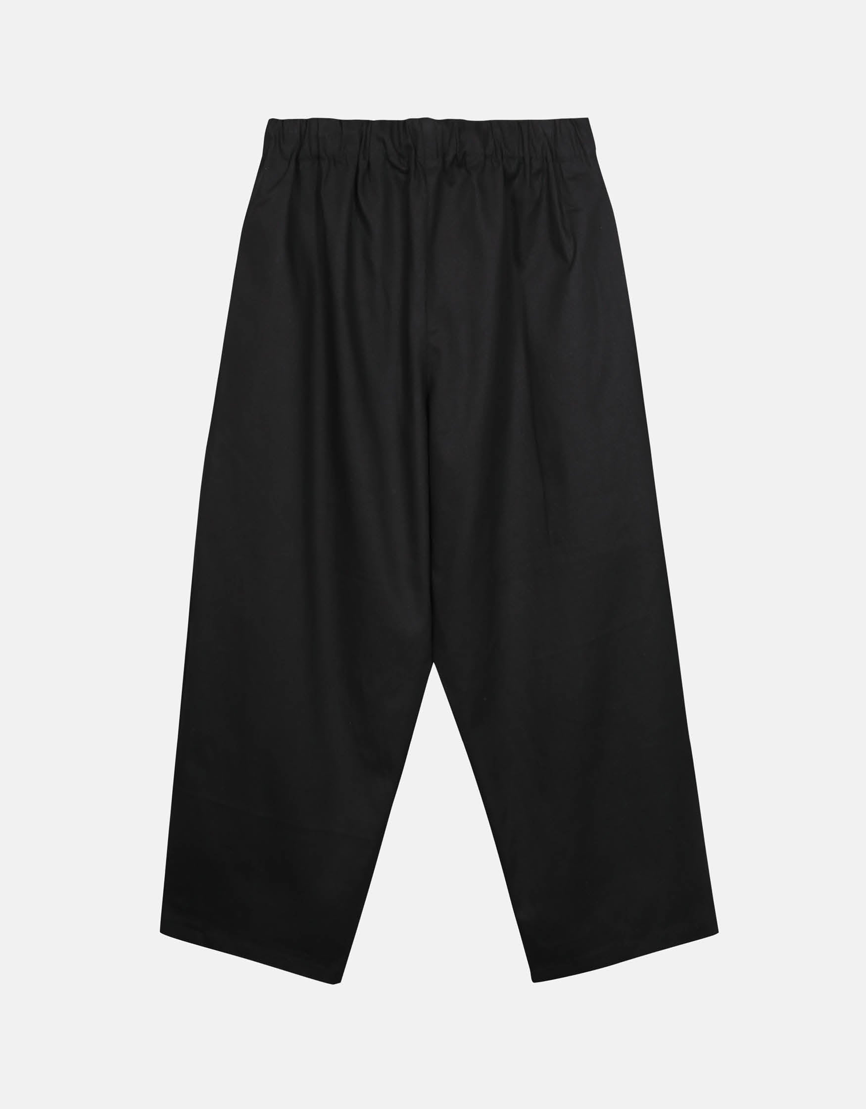 Black minimalist unisex pants with a relaxed curved silhouette and elastic waistband, designed for ease of movement and timeless style.